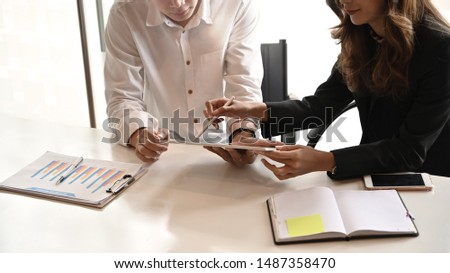 Consulting business people meeting with digital tablet on office table.