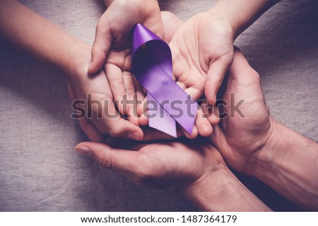 Adult and child hands holding purple ribbons, Alzheimer's disease, Pancreatic cancer, Epilepsy awareness, world cancer day Royalty-Free Stock Photo #1487364179