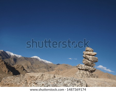 stone tower pattern with mountain scene, blue sky background