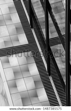 Corner between windows and grid of floor heating radiator. Fragment of modern building interior. Modern architecture design. Hi-tech construction industry with glass and steel or aluminum panels.
