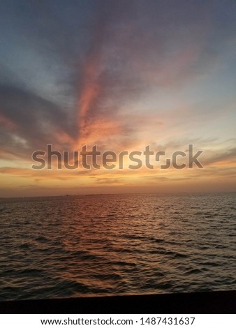 View from Galveston Island Ferry at Sunset. Sunset in the Gulf of Mexico in Galveston, Texas. Peaceful, colorful sunset at dusk.