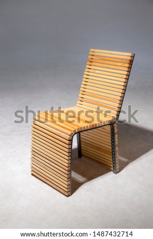 Modern wood chair. Stage lighting with black background