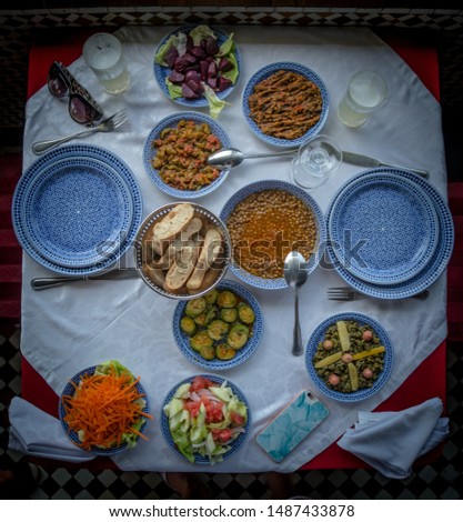 A picture of a table filled with Moroccan dishes.
