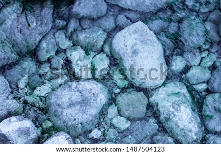 clear blue water flow over the rocky riverbed