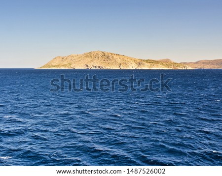 Uninhabited desert island and deep blue sea.