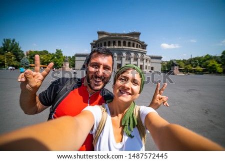 Happy tourist travelling in Armenia taking selfie photo in Yerevan city.