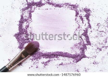 A makeup brush on a white background, with traces of 
eye shadow on it forming a frame. A horizontal template for a makeup school business card or flyer design, with plenty of copyspace