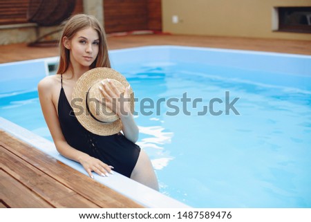 Beautiful girl on a vacation. Lady in the swimming pool