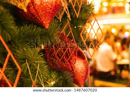 Xmas Festive composition,close up Christmas tree decorated with shiny gold and red ball beautiful interior design, blurred unfocused sparkling bokeh background with golden highlight New Year holiday