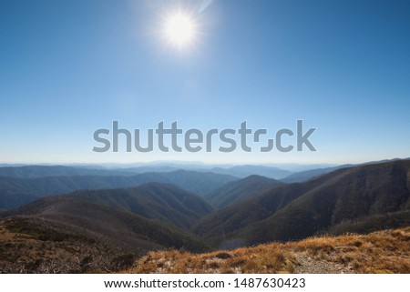 Scenic mountain views with rolling hills and valleys on bright sunny day