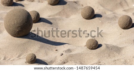 Perfect formed hand made sand balls on  on a sandy beach