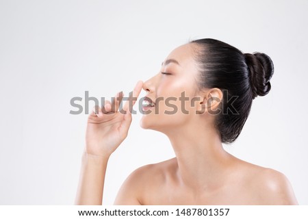 Beautiful Asian woman touching nose smile with clean and fresh skin Happiness and cheerful with positive emotional on white,Plastic Surgery nose,Beauty Cosmetics and spa facial treatment Concept Royalty-Free Stock Photo #1487801357