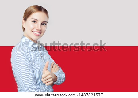 Beautiful woman showing thumb up on the Poland flag background. Travel and learn polish language concept Royalty-Free Stock Photo #1487821577