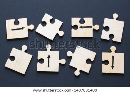 Choice concept, arrows drawn on wooden puzzles. 