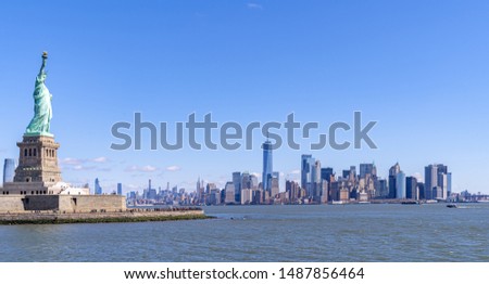 Statue of Liberty with Manhattan downtown  Skylines building in background, New York City , NYC USA.