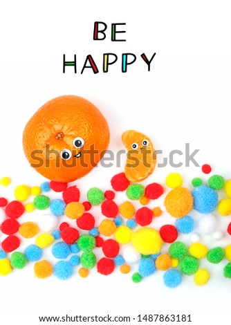 Be happy. Funny tangerine and tangerine slice with smile and festive colorful fluffy balls confetti on white background. Festive party, creative concept idea. Tangerines with Friendly Faces