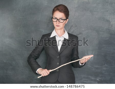 Strict teacher with wooden stick  Royalty-Free Stock Photo #148786475