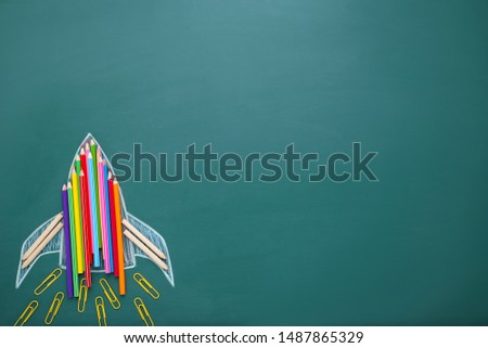 Rocket drawing on chalkboard with colorful crayons