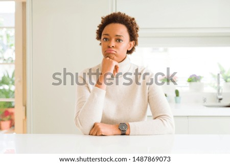 Young beautiful african american woman at home thinking looking tired and bored with depression problems with crossed arms.