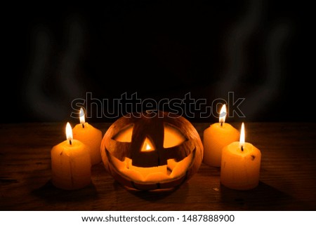 Halloween Pumpkin with candles lights on wooden background