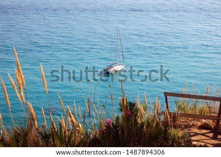 A yacht is sailing in the Tyrrhenian sea in Capo Vaticano, Italy.