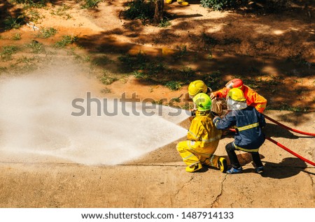 Firefighters spray high-pressure water to areas that are copied in practice.