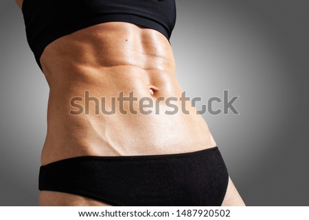 Young athletic woman training abs
