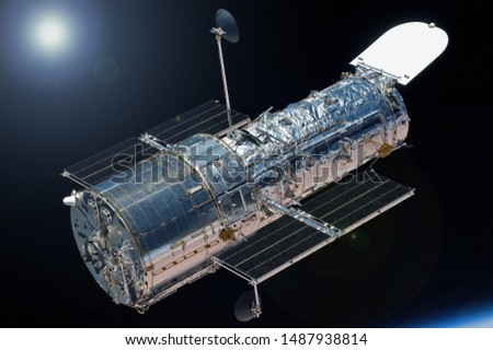 Space Telescope, above the planet Earth, with the sun.  Elements of this image were furnished by NASA Royalty-Free Stock Photo #1487938814