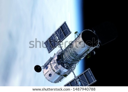 Space Telescope, above the planet Earth.  Elements of this image were furnished by NASA Royalty-Free Stock Photo #1487940788