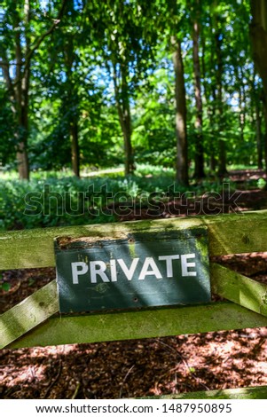 Private sign on a gate in the countryside. Old shooting estate with private land used for field sports.