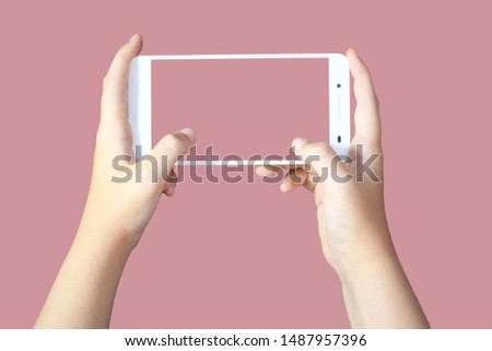  taking picture with white cellphone on a light brown background Royalty-Free Stock Photo #1487957396