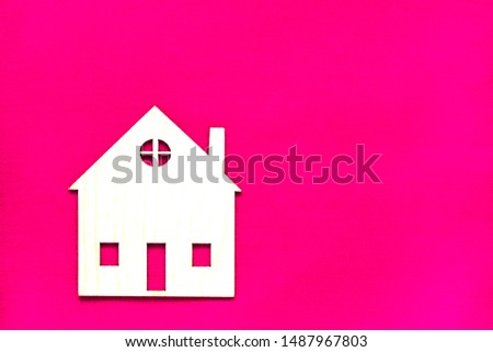 Wooden lodge. Housing. Construction of fence from wood.Concept purchase, rent of housing. The image of the house on a pink background.
