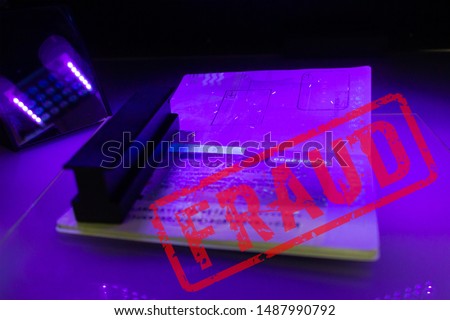 Process of the passport visa checking, close-up. The study of protective elements of the document in ultraviolet light. High security printing for for visa stickers. Passport protection against fraud Royalty-Free Stock Photo #1487990792
