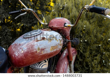 Detail of a grunge vintage motorcycle. Photo of an old gas tank. Close-up.