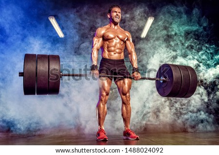 Strong Muscular Men Performing Heavy Deadlift Exercise With Barbells Royalty-Free Stock Photo #1488024092