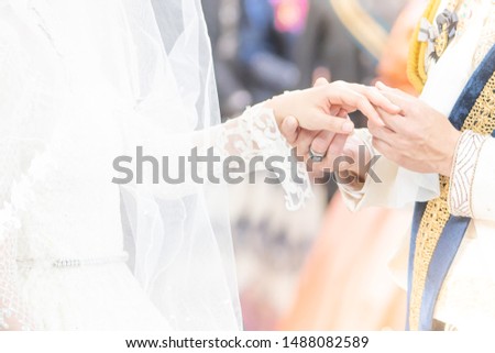 Couple in love holding hands on blurred  background ,Vintage style picture.Happy bride and groom holding hands and walking in field on wedding day.soft focus.