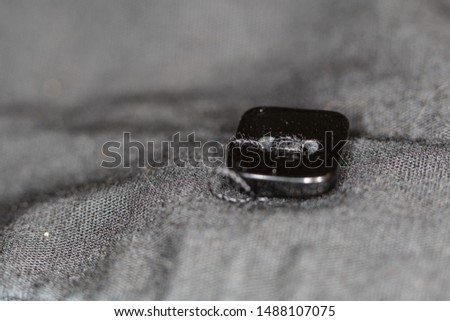 black and white picture of a shirt button
