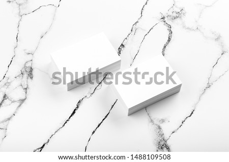 Photo of white business cards on white marble. Template for branding identity isolated on marble background. For graphic designers presentations and portfolios marble premium luxury mock-up. 