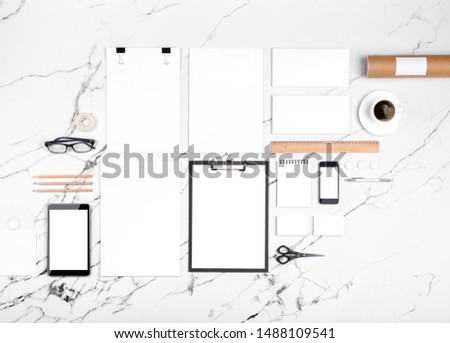 Photo of branding identity mock up on white marble. Template isolated on white marble background. For graphic designers presentations and portfolios marble premium luxury mock-up