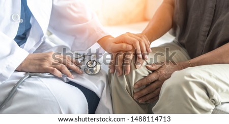 Parkinson's disease patient, Arthritis hand and knee pain or mental health care concept with geriatric doctor consulting examining elderly senior aged adult in medical exam clinic or hospital Royalty-Free Stock Photo #1488114713