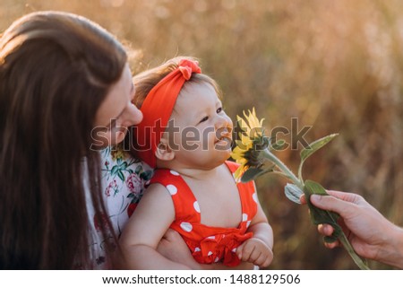 Happy family: mother father and child daughter on nature on sunset 
