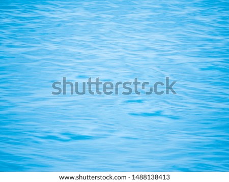Smooth curve lines of blurred textured surface of movements calm waves in clear clean aqua blue ocean or sea can use for abstract or art painting background.
