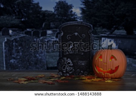 halloween pumpkin glowing in graveyard