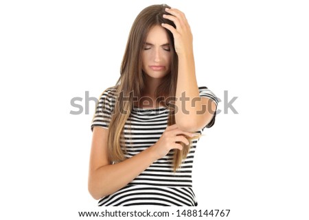Young woman having a headache on white background