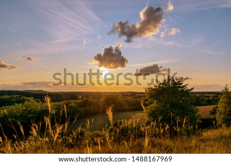 A beautiful sunset with a golden sunshine on a late summer evening. Concept: landscape or travel