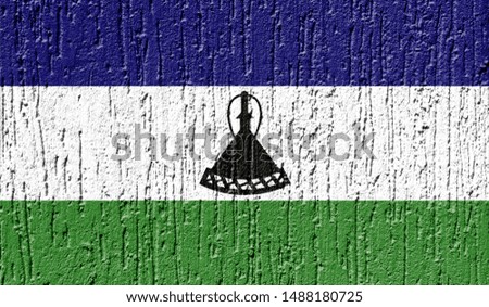Flag of Lesotho close up painted on a cracked wall