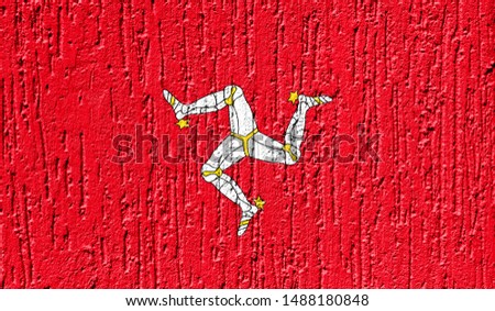 Flag of Isle Of Man close up painted on a cracked wall
