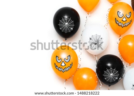 Colored balloons with faces, for Halloween party on white background. Space for text. Happy orange holiday air flying balloon