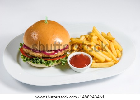 burger with chicken cutlet and fries on a white backgroun