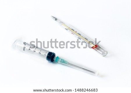 Empty syringe and thermometer closeup isolated on white background. High resolution. Injection. Vaccination. The medicine. Medical procedures and procedures.
